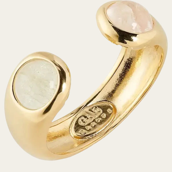 Gold ring with moonstone stones on a white background