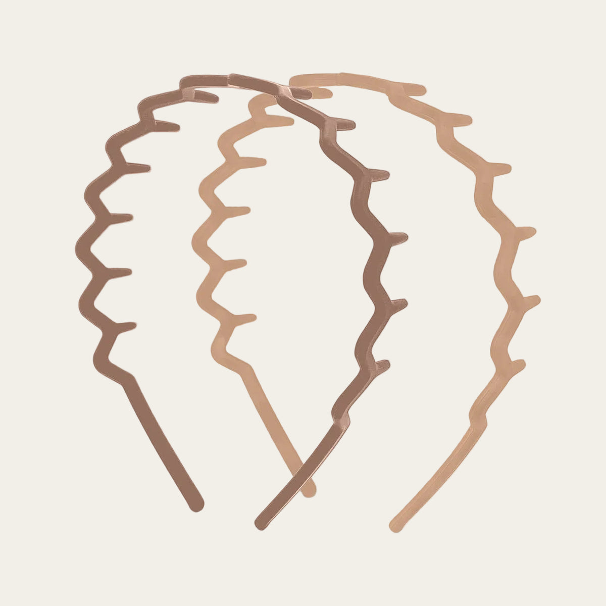 paire of neutral coloured zig zag headbands on a neutral background
