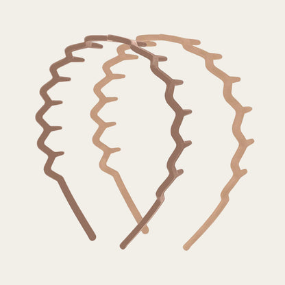 paire of neutral coloured zig zag headbands on a neutral background