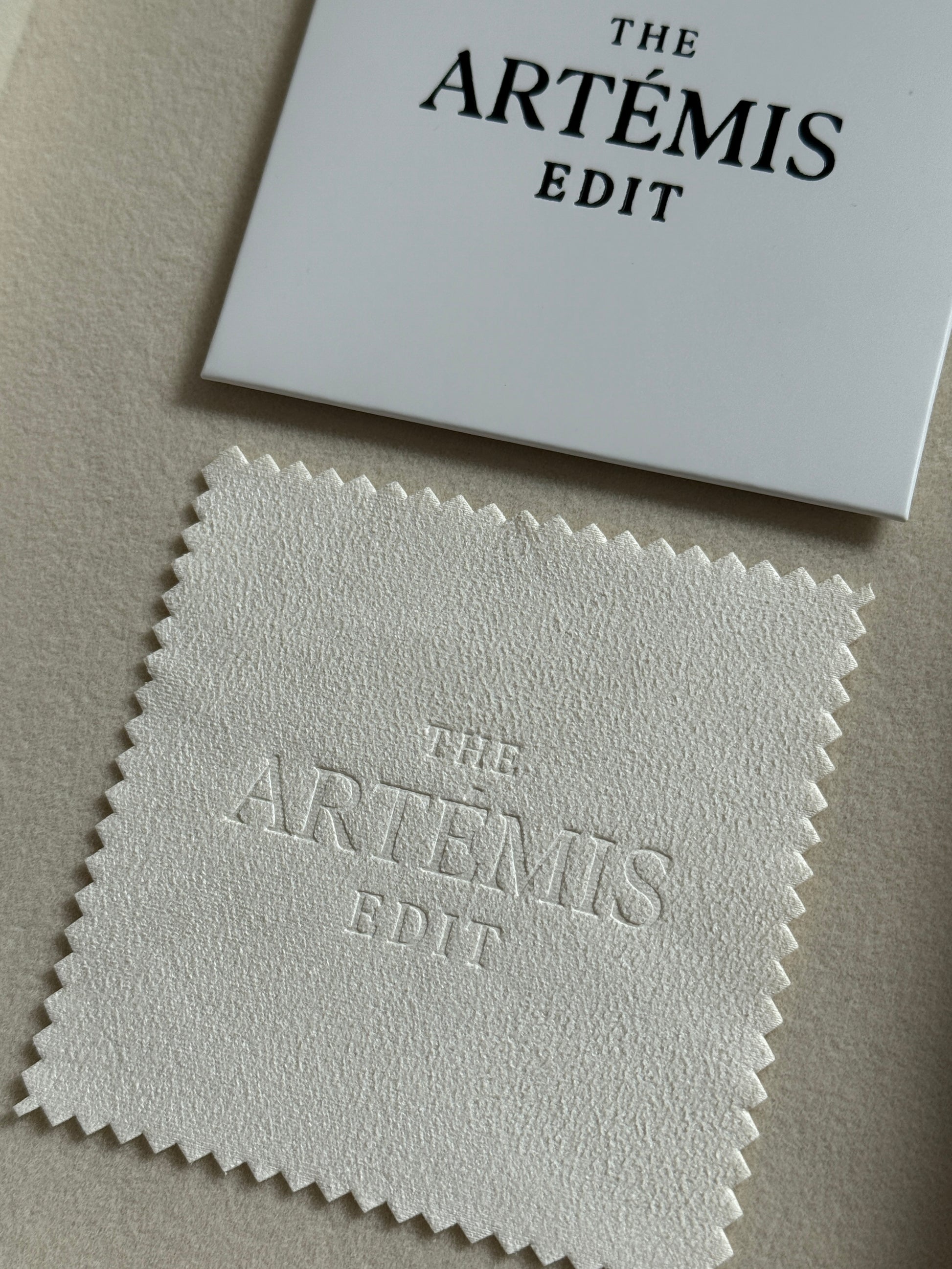 TAE jewellery cloth with white branded sleeve