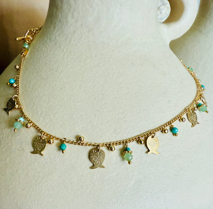 Gold necklace with fish charms on a mannequin bust