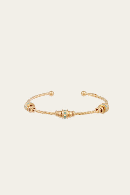 Gold bracelet with small turquoise beads on a white background