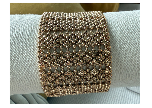 gold plated bracelet cuff on neutral background