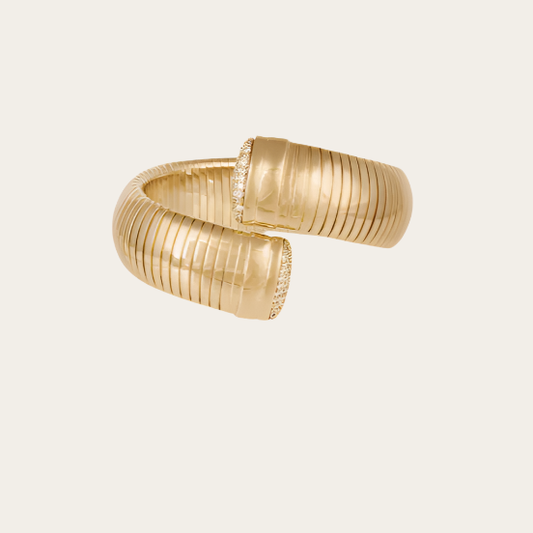 Gold bracelet on a beige background
