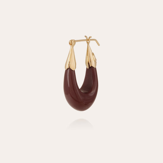 a single gold-tone drop earrings with a smooth finish and dark maple resin accents.