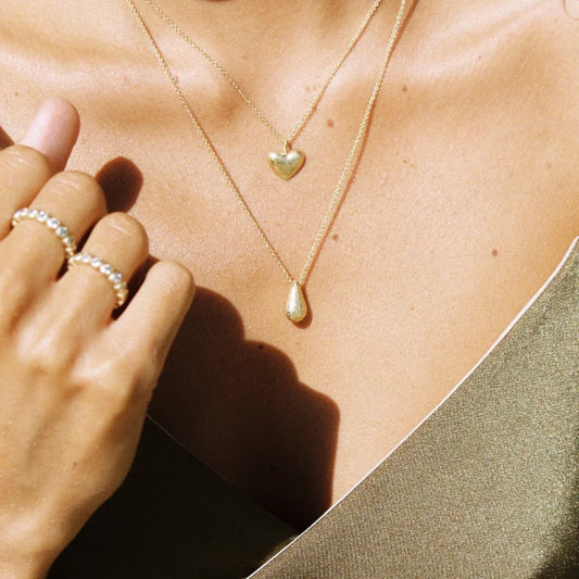 Agapee gold plated Necklace stacked on model neck