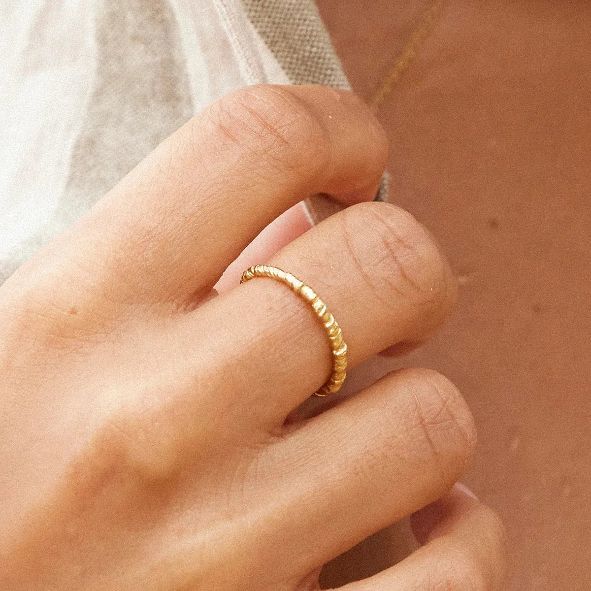 Agapee Zetita ring close up on model hand with neutral background