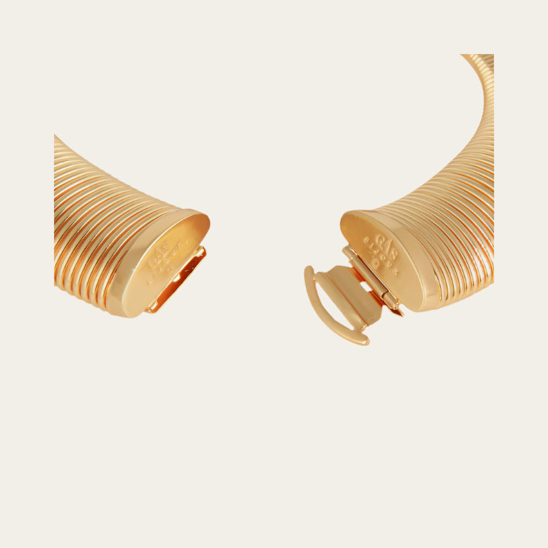 Gold necklace tint on a light beige background