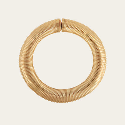 A close-up image of a gold necklace on flat lay neutral available at The Artemis Edit