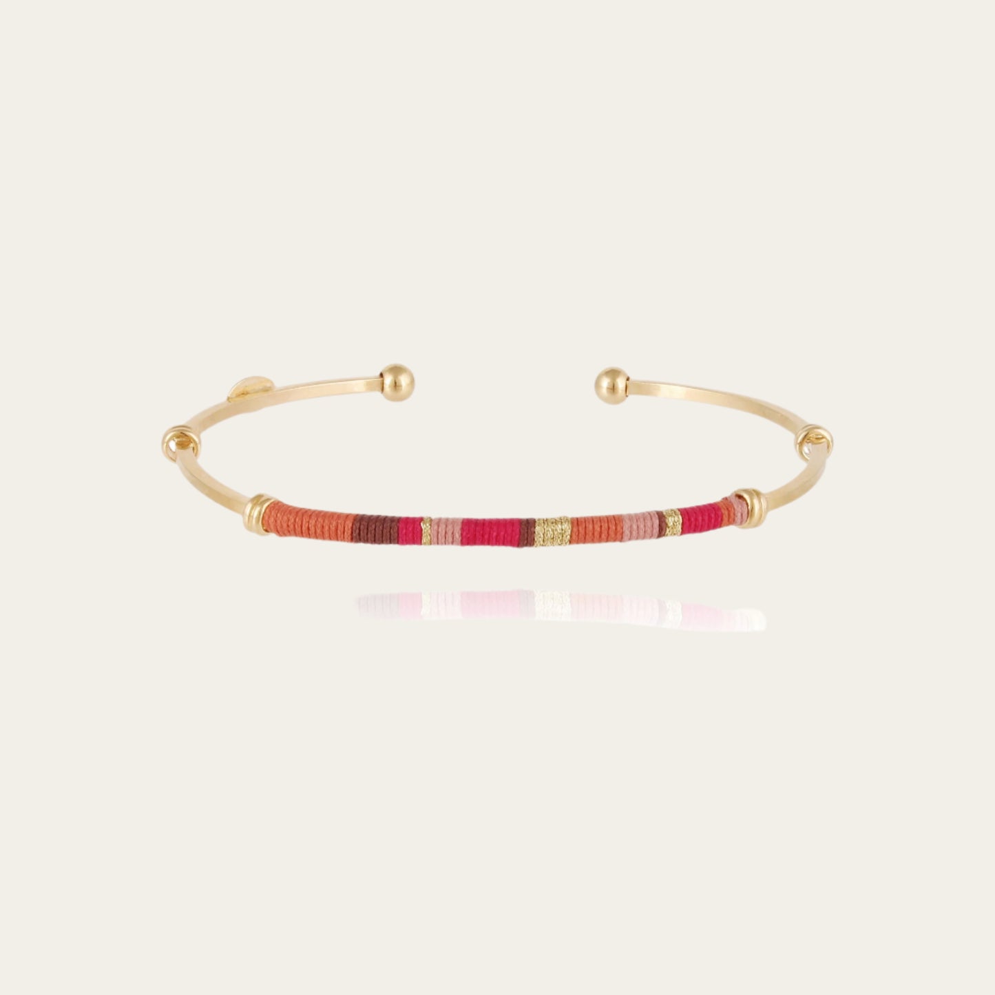 zanzibar gold bangle with different colour threads packshot on white background