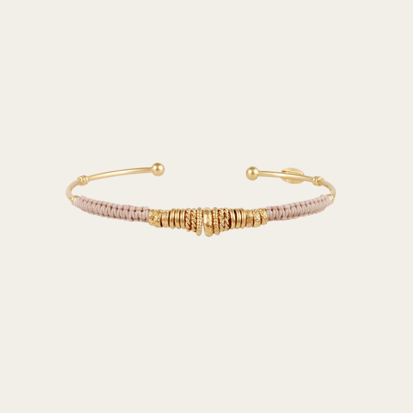 Gold and rose gold bangle on a white background