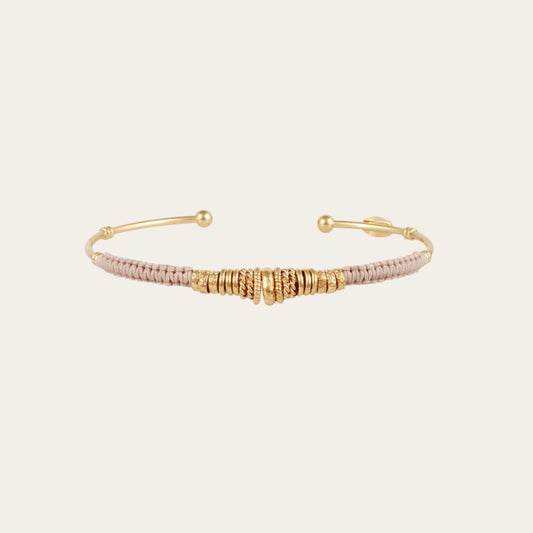 Gold and rose gold bangle on a white background