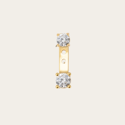 Gold earring with two diamond stones on a white background