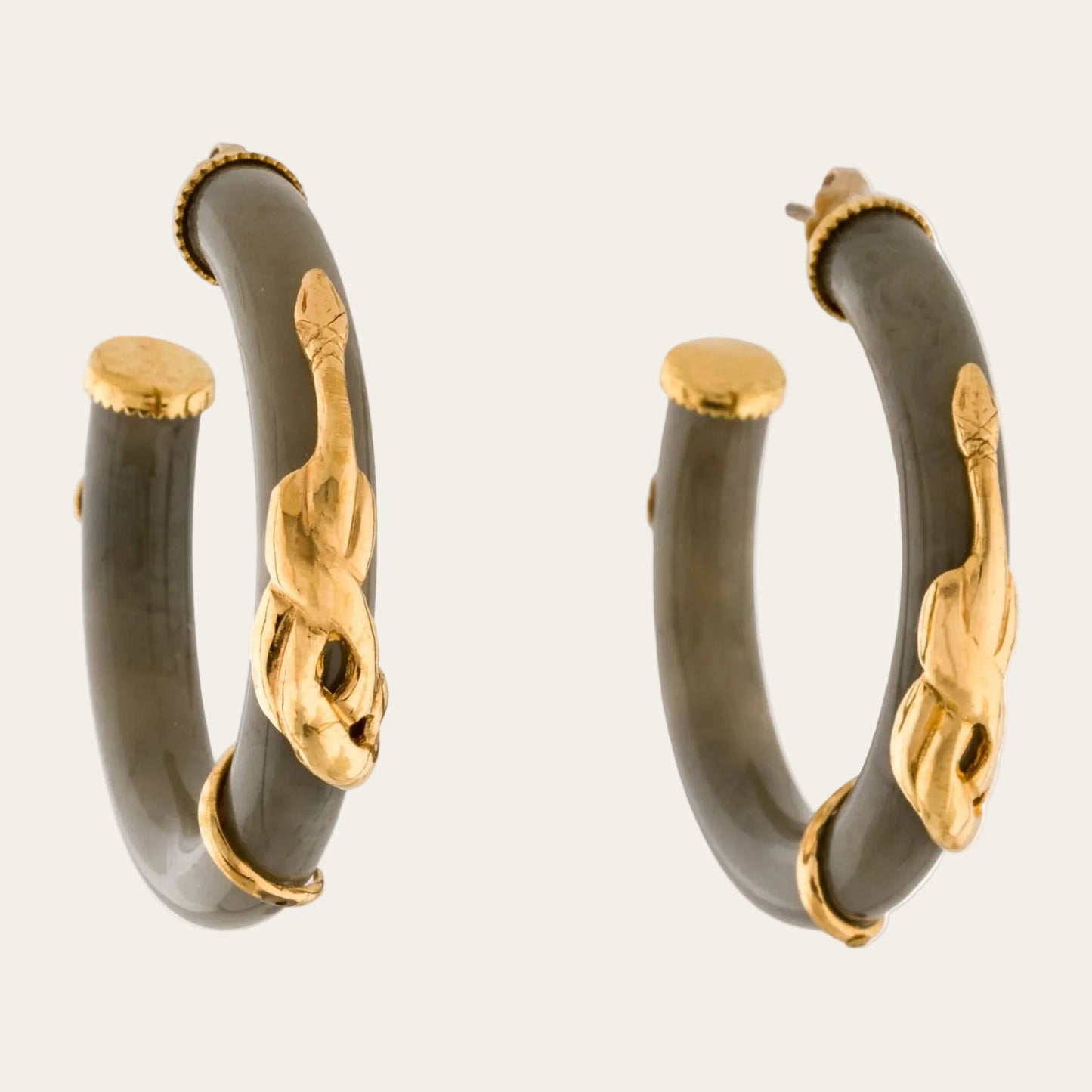 A pair of gold hoop earrings with dark gray stone inlays and gold-toned decorative accents, shown on a plain white background.