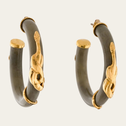 A pair of gold hoop earrings with dark gray stone inlays and gold-toned decorative accents, shown on a plain white background.