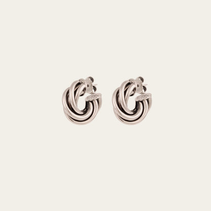 Pair of silver hoop earrings on a light gray background