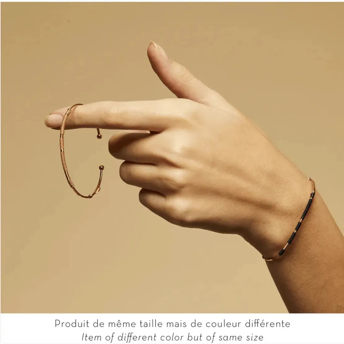 zanzibar gold plated bangle on model hand, close up image