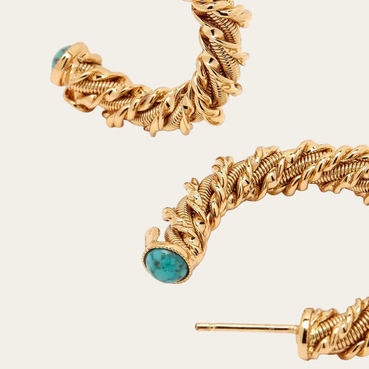 Gold hoop earrings with turquoise stones on a white background