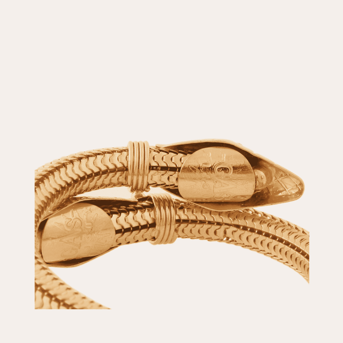 Gold bracelet on a light beige background