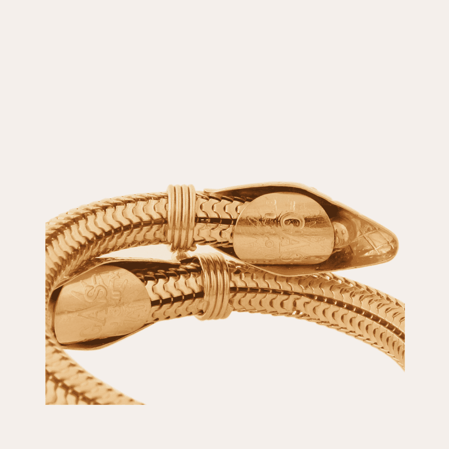 Gold bracelet on a light beige background