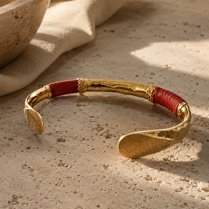 gold bracelet against travertine surface