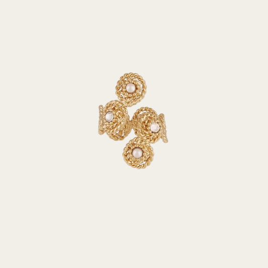 gold intertwined ring with stones on a white background
