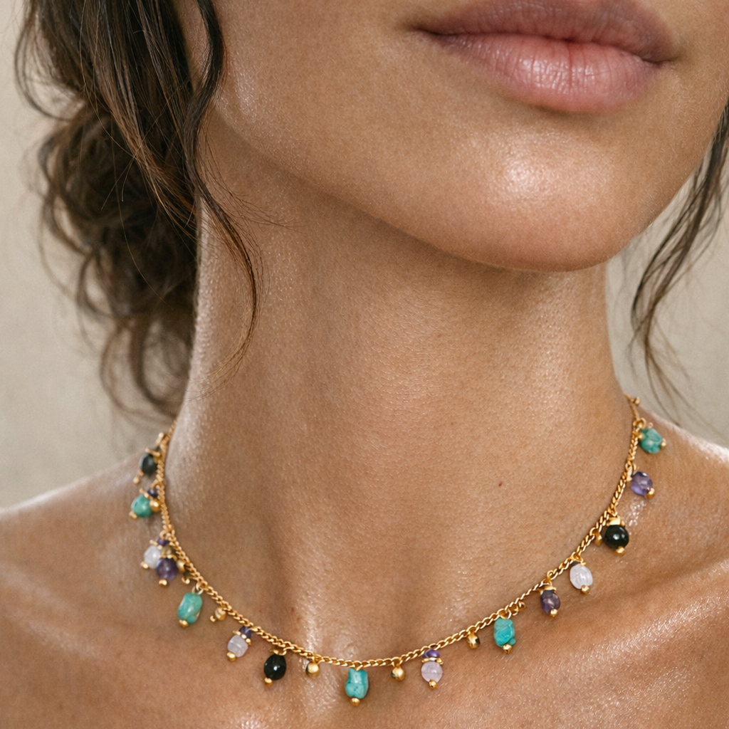 close up of gold and turquoise necklace on woman