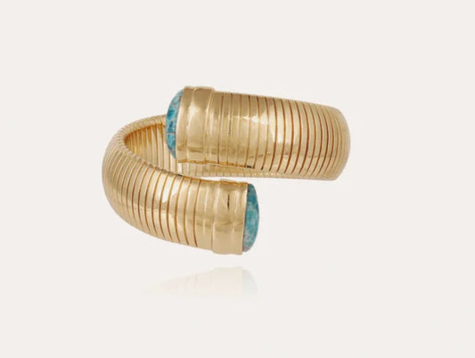 Gold ring with blue gemstones on a white background