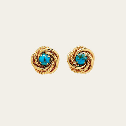 Pair of gold earrings with turquoise stones on a white background