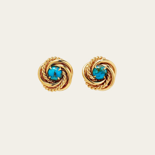 Pair of gold earrings with turquoise stones on a white background