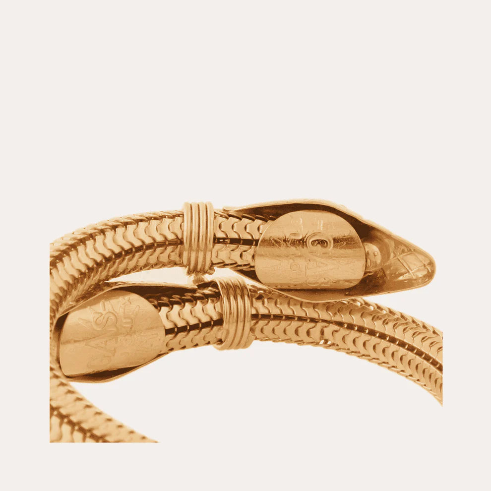 Gold bracelet on a light beige background