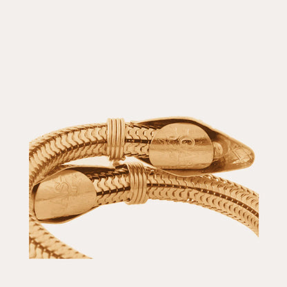 Gold bracelet on a light beige background