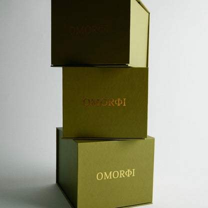 Three stacked boxes with 'OMORFI' branding on a light gray background