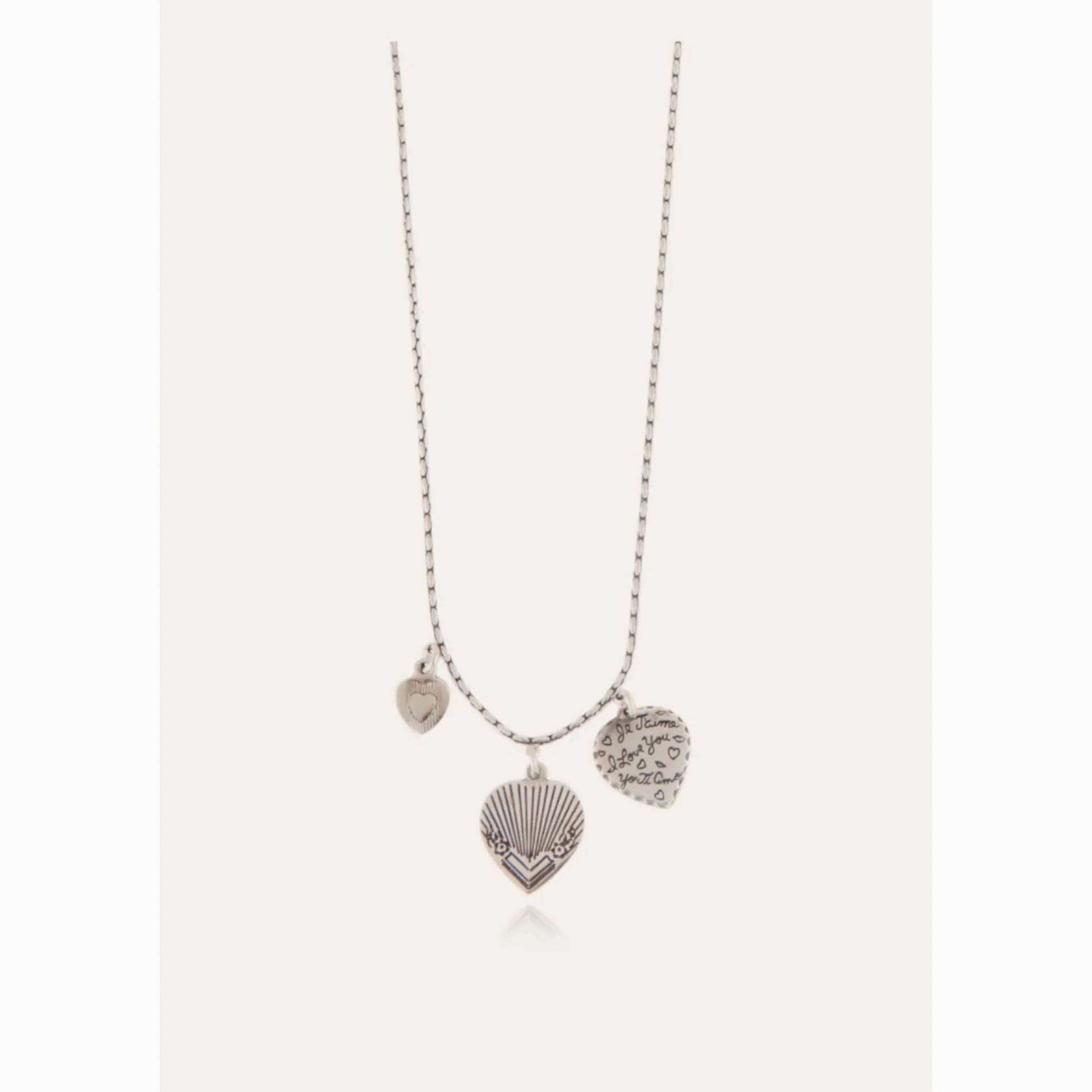 Necklace with heart-shaped and shell-shaped pendants on a white background
