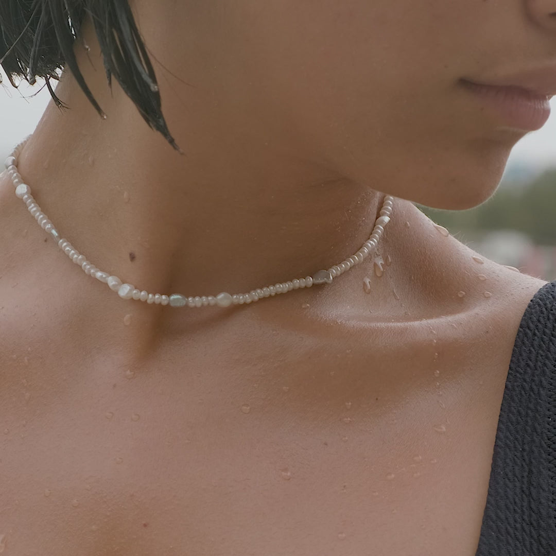 pearl choker on woman 