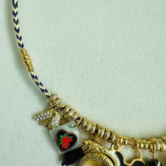 Necklace with charms and threaded cotton on neutral background