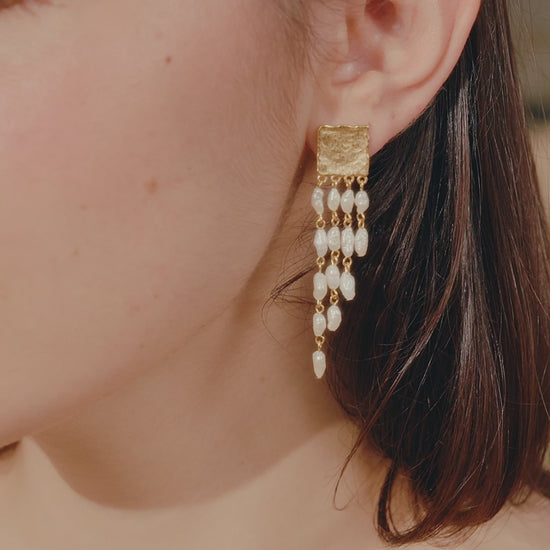 woman wearing sappho drop pearl earrings