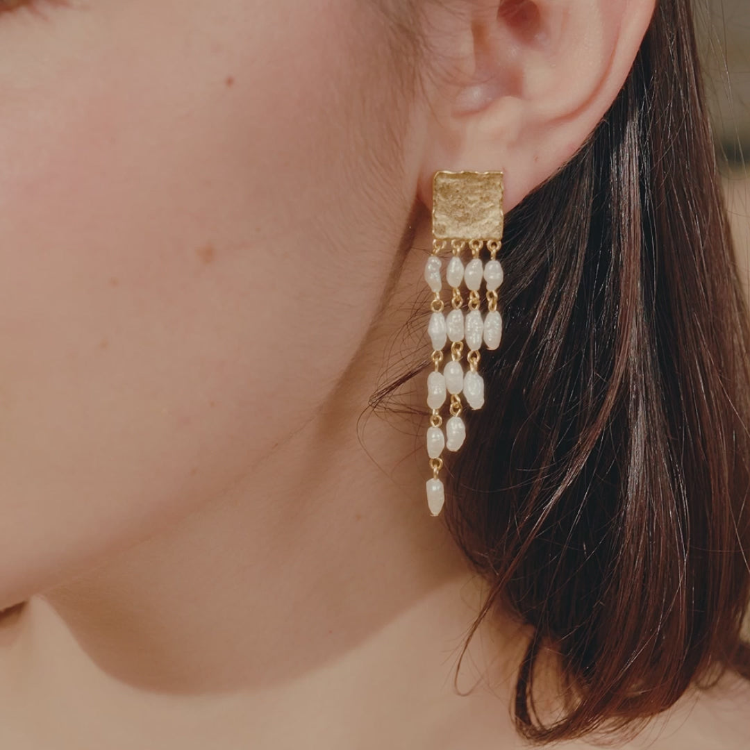 woman wearing sappho drop pearl earrings
