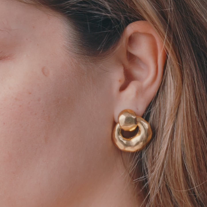 video of gold earrings on woman