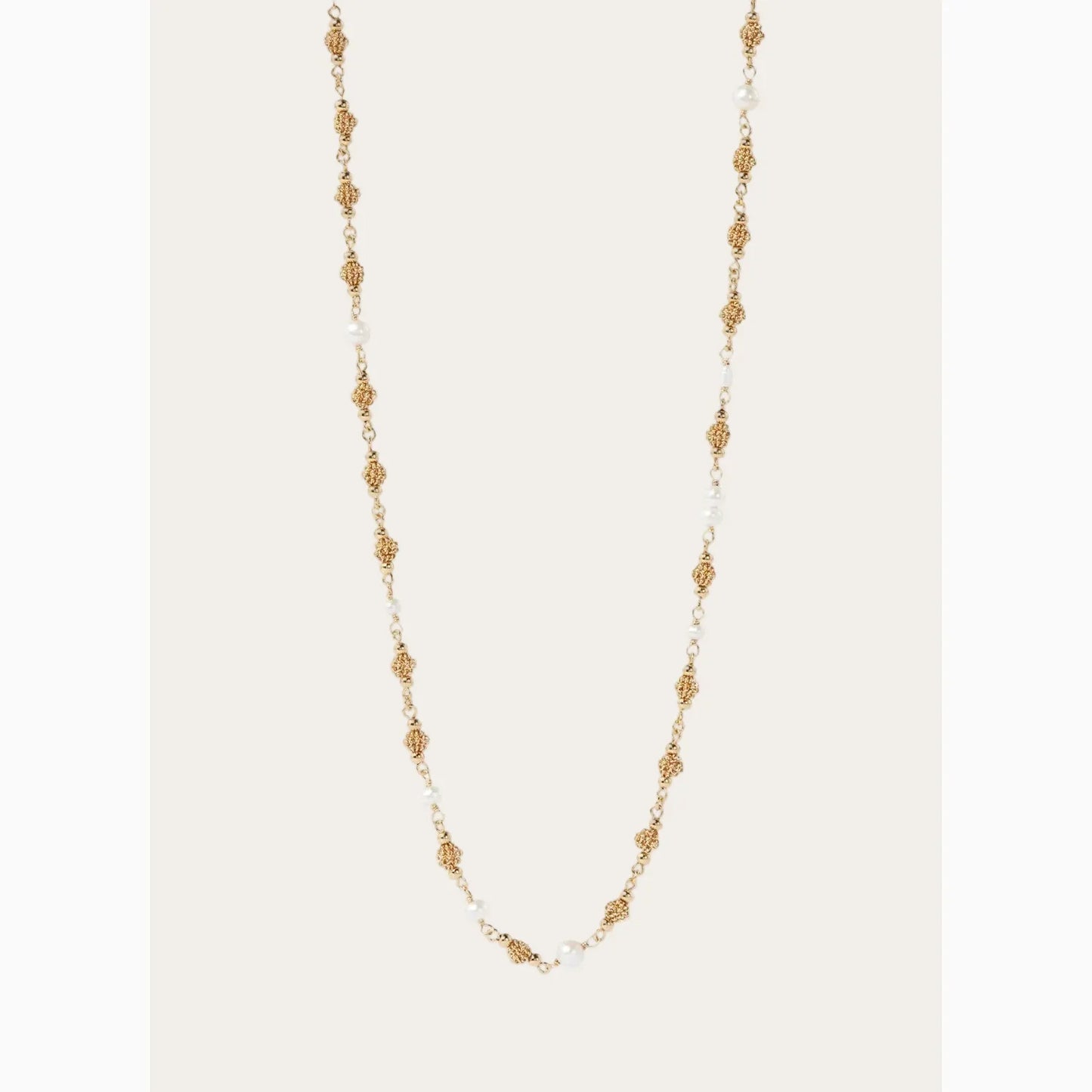 Gold and pearl necklace on a white background