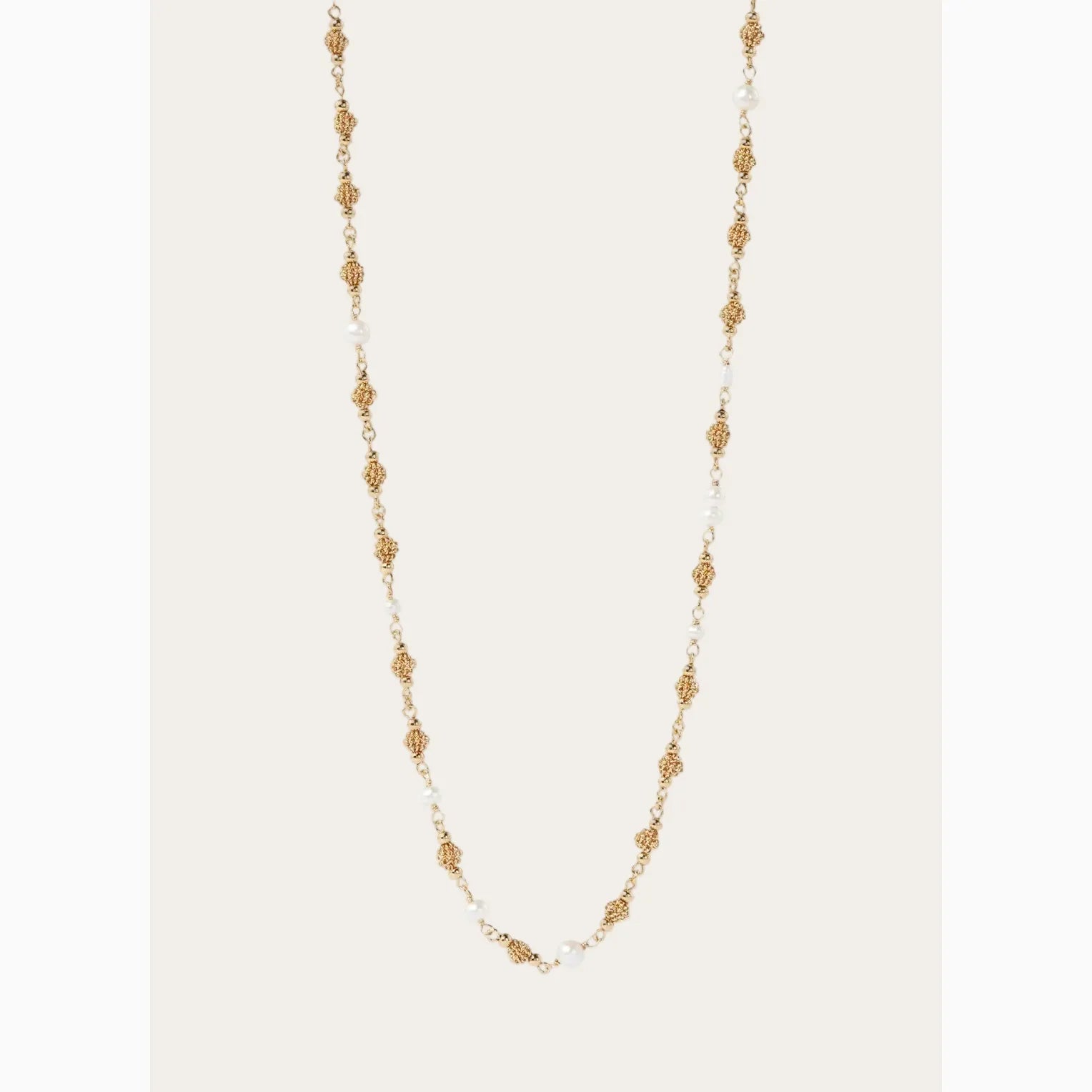 Gold and pearl necklace on a white background