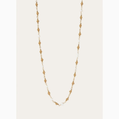 Gold and pearl necklace on a white background